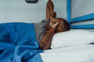 pessoa deitada na cama com sono