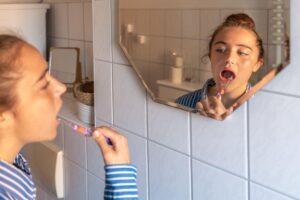 menina escovando o dente