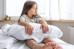 criança sentada na cama